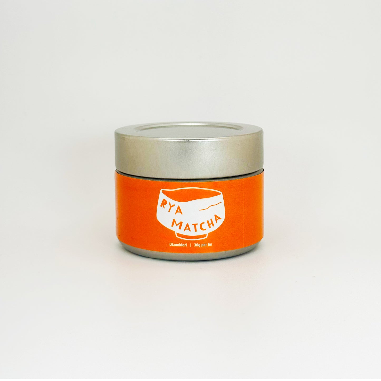 Rya Matcha tin with an orange label on a silver can with a silver lid. It is an Okumidori variety in a 30 gram tin.