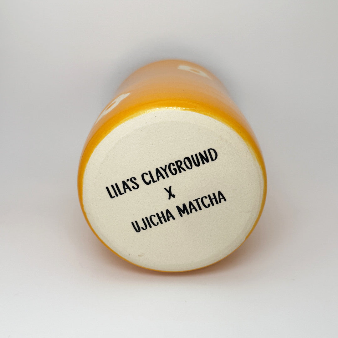 Orange Straw Cup - Lila's Clayground X Ujicha Matcha. Bottom of the cup showing the collab.
