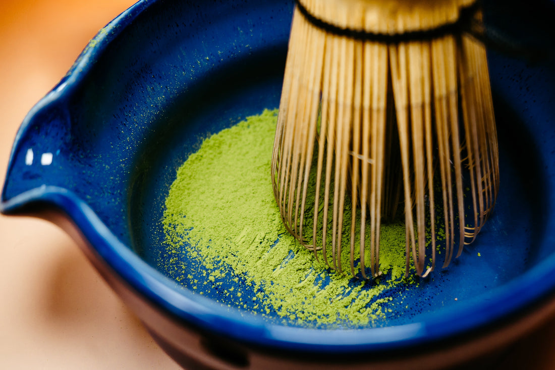 Rya Saemidori Ceremonial Grade Matcha being whisked in a blue bowl from Ujicha Matcha