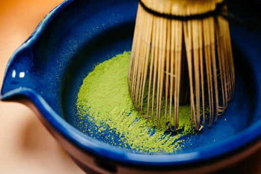Rya Saemidori Ceremonial Grade Matcha being whisked in a blue bowl from Ujicha Matcha