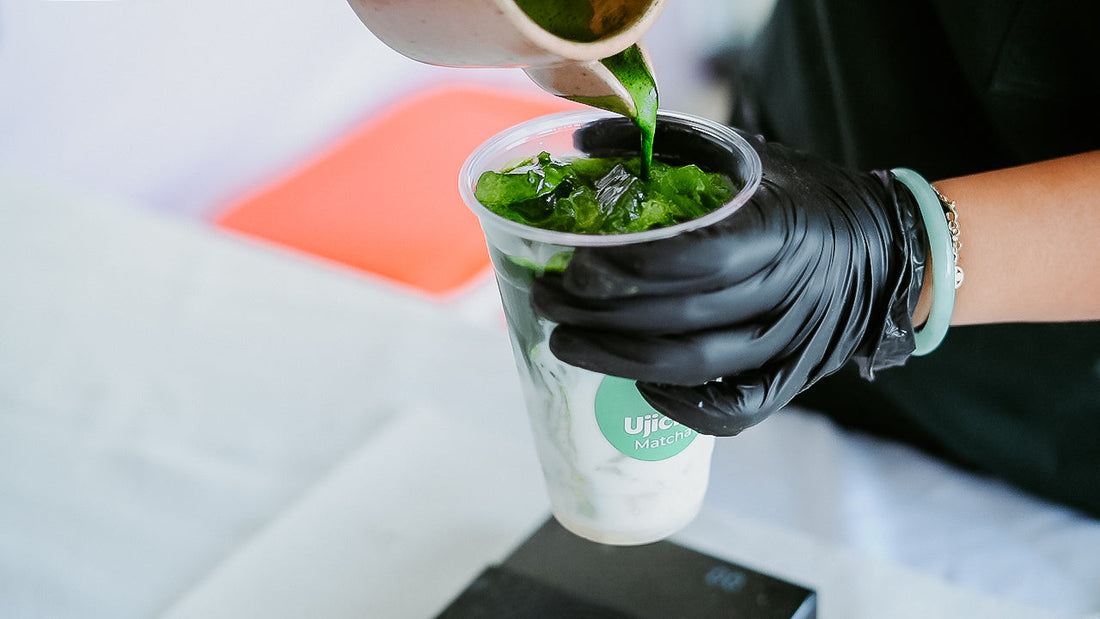 A Ujicha Matcha machista pouring Rya matcha into a cup at a pop up