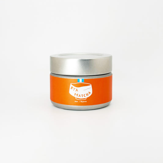 Kirari Matcha by Rya Matcha in a silver tin with an orange and white label with the Rya Matcha Logo on it.