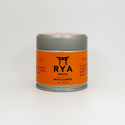 Orange and silver RYA matcha container on a white background