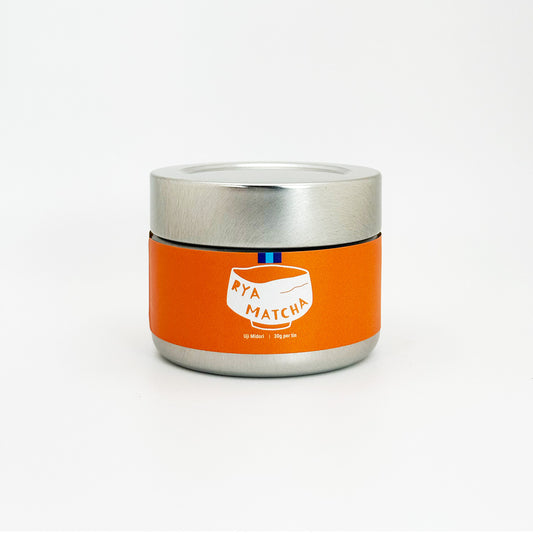 Silver container with orange label featuring 'Rya Matcha' on a white background. Its the Uji Midori varient of Rya Matcha.